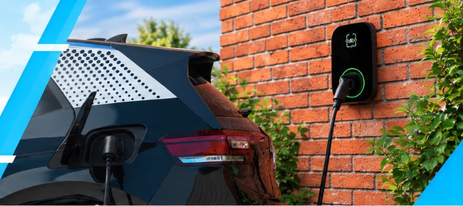 Dark blue EV charging from a wall-mounted charger on a red brick wall